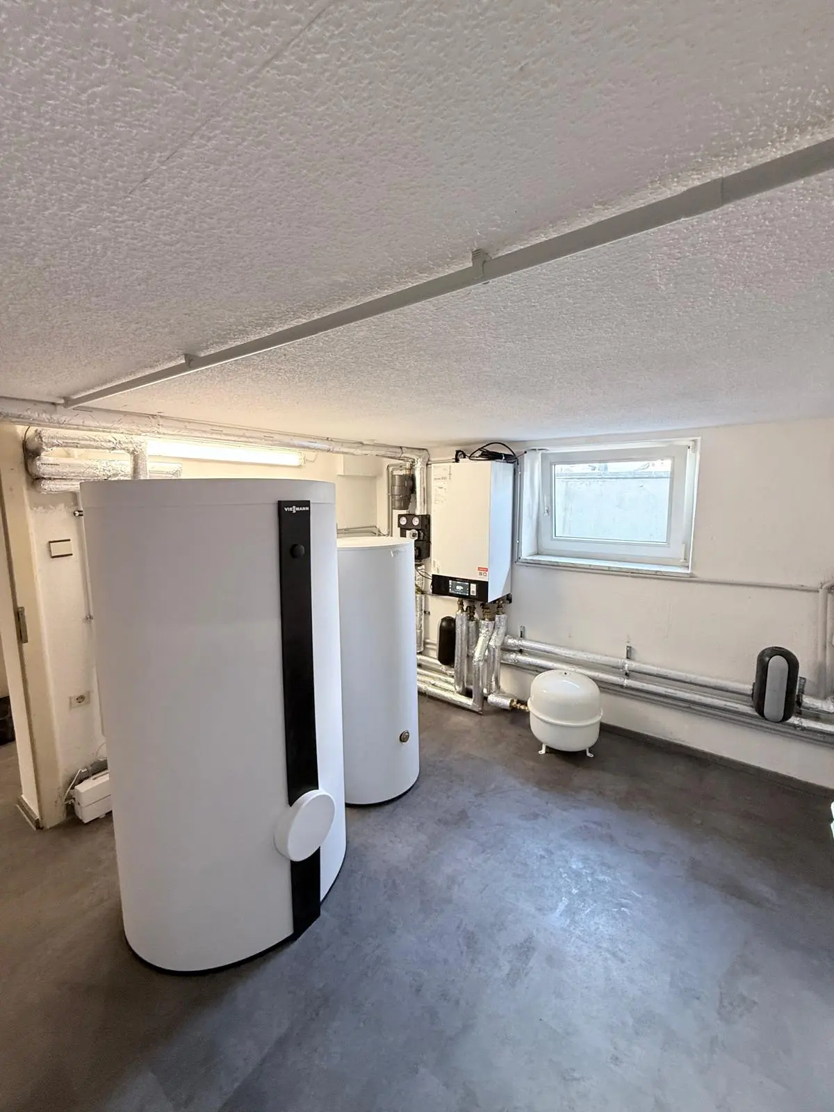 Plant room with the hot-water tank of a heat pump in Essen